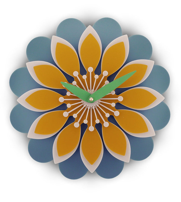 Decorative wall clock with a floral design featuring blue and orange petals on a white background.