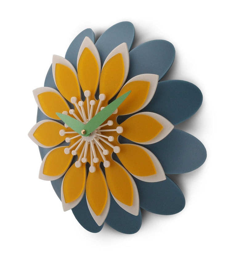 Floral wall clock with yellow and blue petals on a white background